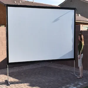 A large free-standing movie screen set up in a backyard.